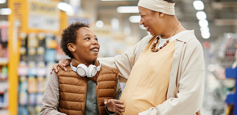 A pregnant mother and her child visit a local grocery story.