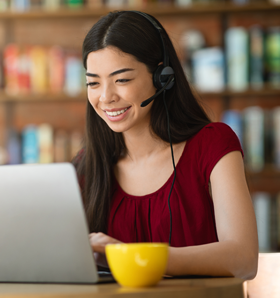 A webinar attendee joins the event from their laptop wearing a headset.